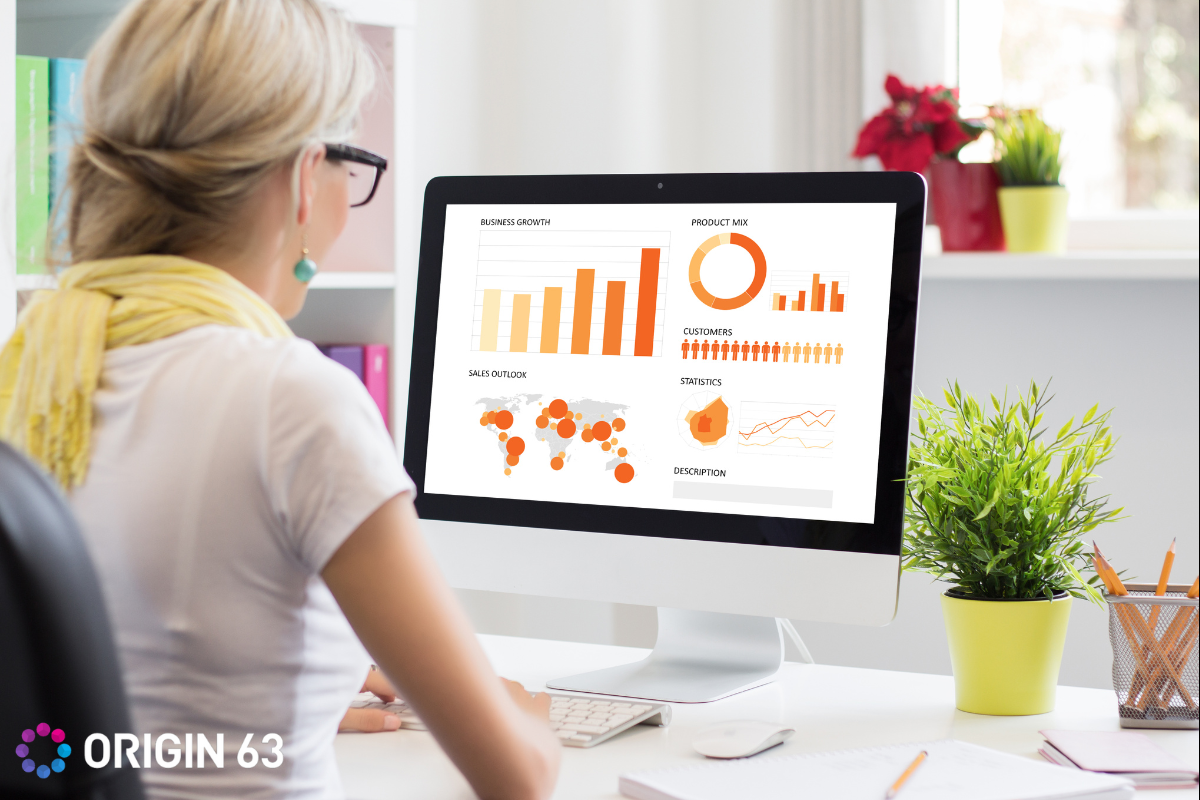 A business leader looking at data, Overcoming Reporting Challenges for Smarter Business Decisions