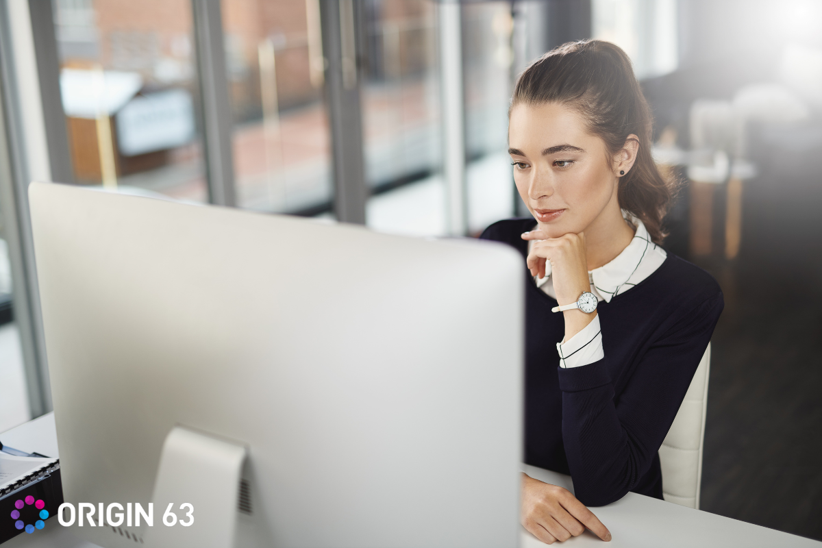 A thoughtful businesswoman using buyer intent with HubSpot Breeze Intelligence